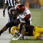 San Diego State's Rashaad Penny (20) gets forced out of bounds by Arizona State's Joey Bryant, bottom, during the first half of an NCAA college football game Saturday, Sept. 9, 2017, in Tempe, Ariz. (AP Photo/Ross D. Franklin)