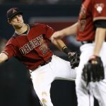 Arizona Diamondbacks' Jake Lamb makes an off balance throw to first base but is unable to get San Diego Padres' Wil Myers out during the eighth inning of a baseball game Sunday, Sept. 10, 2017, in Phoenix. The Padres' Myers got an infield single on the play but the Diamondbacks defeated the Padres 3-2. (AP Photo/Ross D. Franklin)