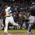 Arizona Diamondbacks' Gregor Blanco, left, scores a run as Colorado Rockies' Tony Wolters, right, pauses at home plate during the first inning of a baseball game Thursday, Sept. 14, 2017, in Phoenix. (AP Photo/Ross D. Franklin)
