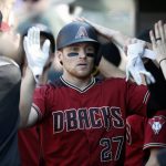 Arizona Diamondbacks' Brandon Drury is congratulated as he returns to the dugout after hitting a two-run home run off Colorado Rockies starting pitcher German Marquez in the sixth inning of a baseball game Sunday, Sept. 3, 2017, in Denver. (AP Photo/David Zalubowski)