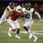 Northern Arizona running back Joe Logan (22) rushes for a first down against Arizona during the first half of an NCAA college football game, Saturday, Sept. 2, 2017, in Tucson, Ariz. (AP Photo/Rick Scuteri)