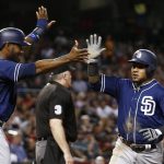 San Diego Padres' Jabari Blash (32) and Erick Aybar, right, celebrate after both scored against the Arizona Diamondbacks during the fourth inning of a baseball game Friday, Sept. 8, 2017, in Phoenix. (AP Photo/Ross D. Franklin)