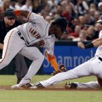Arizona Diamondbacks' David Peralta (6) is tagged out by San Francisco Giants' Orlando Calixte on an attempted steal during the first inning of a baseball game, Tuesday, Sept. 26, 2017, in Phoenix. (AP Photo/Matt York)
