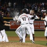 Arizona Diamondbacks' John Ryan Murphy, right, celebrates with teammates, including Jeremy Hazelbaker (41) and Kris Negron (45) as David Peralta, middle, is doused with a liquid after his bases loaded walk scored the winning run against the San Francisco Giants during the ninth inning of a baseball game Wednesday, Sept. 27, 2017, in Phoenix. The Diamondbacks defeated the Giants 4-3. (AP Photo/Ross D. Franklin)