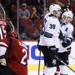 San Jose Sharks' Mikkel Boedker, right, celebrates his second goal of the night with teammate Logan Couture (39) as Arizona Coyotes' Luke Schenn (2) and Brad Richardson (15) pause on the ice during the first period of a preseason NHL hockey game Saturday, Sept. 23, 2017, in Glendale, Ariz. (AP Photo/Ross D. Franklin)