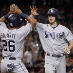 San Diego Padres' Wil Myers (4) high fives teammate Yangervis Solarte (26) after hitting a two run home run agasint the Arizona Diamondbacks during the seventh inning of a baseball game, Saturday, Sept. 9, 2017, in Phoenix. (AP Photo/Matt York)