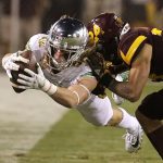 Oregon wide receiver Kyle Buckner, left, dives for a first down as Arizona State defensive back Chase Lucas (24) tackles him during the second half of an NCAA college football game, Saturday, Sept. 23, 2017, in Tempe, Ariz. Arizona State defeated Oregon 37-35. (AP Photo/Rick Scuteri)