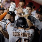 San Francisco Giants' Tim Federowicz (46) is greeted in the dugout after hitting a two-run home run against the Arizona Diamondbacks during the fifth inning of a baseball game, Tuesday, Sept. 26, 2017, in Phoenix. (AP Photo/Matt York)
