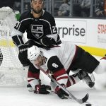 Arizona Coyotes center Tobias Rieder, of Germany, falls as he goes after the puck while under pressure from Los Angeles Kings defenseman Alec Martinez during the first period of a preseason NHL hockey game, Thursday, Sept. 28, 2017, in Los Angeles. (AP Photo/Mark J. Terrill)