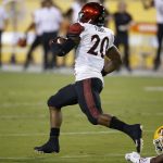 San Diego State's Rashaad Penny (20) breaks a tackle against Arizona State on his way to a 95-yard touchdown during the first half of an NCAA college football game Saturday, Sept. 9, 2017, in Tempe, Ariz. (AP Photo/Ross D. Franklin)