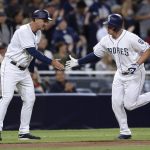 San Diego Padres' Hunter Renfroe is congratulated by Glenn Hoffman as he rounds third base after hitting a home run during the fifth inning of a baseball game against the Arizona Diamondbacks Wednesday, Sept. 20, 2017, in San Diego. (AP Photo/Orlando Ramirez)