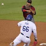Los Angeles Dodgers' Yasiel Puig, below, is forced out at second as Arizona Diamondbacks shortstop Ketel Marte throws out Chase Utley at first during the second inning of a baseball game, Wednesday, Sept. 6, 2017, in Los Angeles. (AP Photo/Mark J. Terrill)