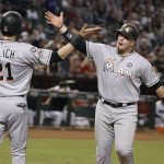 Miami Marlins' Justin Bour, right, is congratulated by Christian Yelich (21) after hitting a three-run home run against the Arizona Diamondbacks during the third inning of a baseball game, Friday, Sept. 22, 2017, in Phoenix. (AP Photo/Ralph Freso)