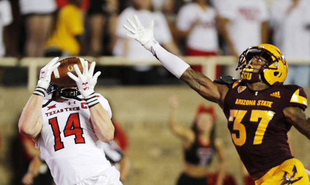 Texas Tech receiver Dylan Cantrell makes a touchdown reception while defended by Arizona State's Jo...