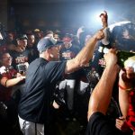 Arizona Diamondbacks manager Torey Lovullo celebrates with players in the locker room after clinching a National League Wild Card playoff spot after a baseball game against the Miami Marlins, Sunday, Sept. 24, 2017, in Phoenix. The Diamondbacks defeated the Marlins 3-2. (AP Photo/Ross D. Franklin)