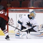 San Jose Sharks' Troy Grosenick (1) makes a save against Arizona Coyotes' Conor Garland (83) during the shootout of a preseason NHL hockey game Saturday, Sept. 23, 2017, in Glendale, Ariz. The Sharks defeated the Coyotes 5-4. (AP Photo/Ross D. Franklin)