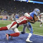 Detroit Lions wide receiver Marvin Jones (11) catches a 6-yard touchdown as Arizona Cardinals cornerback Patrick Peterson (21) defends during the first half of an NFL football game in Detroit, Sunday, Sept. 10, 2017. (AP Photo/Jose Juarez)