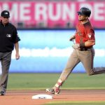 Arizona Diamondbacks' David Peralta rounds the bases after hitting a home run as umpire Greg Gibson watches during the first inning of a baseball game against the San Diego Padres Wednesday, Sept. 20, 2017, in San Diego. (AP Photo/Orlando Ramirez)