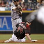 Miami Marlins' Dee Gordon forces out Arizona Diamondbacks Paul Goldschmidt (44) as he turns a double play on J.D. Martinez during the seventh inning of a baseball game, Saturday, Sept. 23, 2017, in Phoenix. (AP Photo/Matt York)