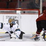 Arizona Coyotes' Max Domi, right, scores a goal against San Jose Sharks' Troy Grosenick (1) during the shootout in a preseason NHL hockey game Saturday, Sept. 23, 2017, in Glendale, Ariz. The Sharks defeated the Coyotes 5-4. (AP Photo/Ross D. Franklin)