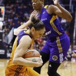 Phoenix Mercury's Diana Taurasi, left, grabs the ball in front of Los Angeles Sparks' Alana Beard, right, during the first half of Game 3 of a WNBA basketball playoff semifinal Sunday, Sept. 17, 2017, in Phoenix. (AP Photo/Ross D. Franklin)