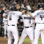Arizona Diamondbacks' Chris Iannetta (8) is congratulated by teammates J.D. Martinez (28), David Peralta (6) and Paul Goldschmidt (44) after hitting a grand slam against the Miami Marlins during the sixth inning of a baseball game, Friday, Sept. 22, 2017, in Phoenix. It was Iannetta's second home run of the game. (AP Photo/Ralph Freso)