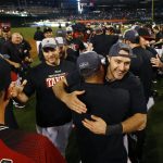 Arizona Diamondbacks' A.J. Pollock, right, smiles as he celebrates with teammates on the field after clinching a National League Wild Card playoff spot after a baseball game against the Miami Marlins, Sunday, Sept. 24, 2017, in Phoenix. The Diamondbacks defeated the Marlins 3-2. (AP Photo/Ross D. Franklin)