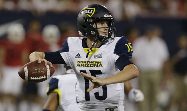 Northern Arizona quarterback Case Cookus looks for a receiver during the first half during an NCAA ...