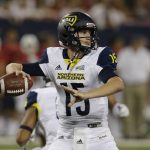 Northern Arizona quarterback Case Cookus looks for a receiver during the first half during an NCAA college football game against Arizona, Saturday, Sept. 2, 2017, in Tucson, Ariz. (AP Photo/Rick Scuteri)