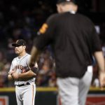 San Francisco Giants starting pitcher Matt Moore waits as manager Bruce Bochy heads out to remove Moore, who had given up a grand slam to the Arizona Diamondbacks during the second inning of a baseball game, Tuesday, Sept. 26, 2017, in Phoenix. (AP Photo/Matt York)