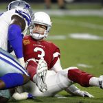 Arizona Cardinals quarterback Carson Palmer (3) looks at Dallas Cowboys defensive end Demarcus Lawrence after being sacked during the second half of an NFL football game, Monday, Sept. 25, 2017, in Glendale, Ariz. (AP Photo/Ross D. Franklin)