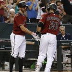 Arizona Diamondbacks' J.D. Martinez (28) shakes hands with Adam Rosales, left, after Martinez hit a home run against the San Diego Padres during the sixth inning of a baseball game Sunday, Sept. 10, 2017, in Phoenix. The Diamondbacks' Martinez had two home runs on the day and the Diamondbacks defeated the Padres 3-2. (AP Photo/Ross D. Franklin)