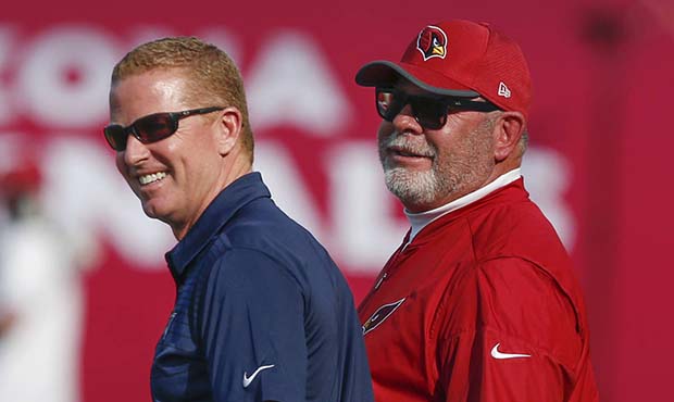 Arizona Cardinals coach Bruce Arians, right, and Dallas Cowboys coach Jason Garrett talk before the...