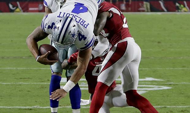 Dallas Cowboys quarterback Dak Prescott (4) dives for a touchdown as Arizona Cardinals cornerback J...