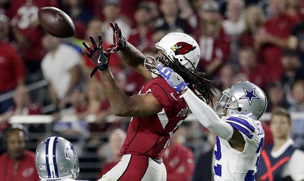 Arizona Cardinals wide receiver Larry Fitzgerald (11) makes the catch as Dallas Cowboys free safety...