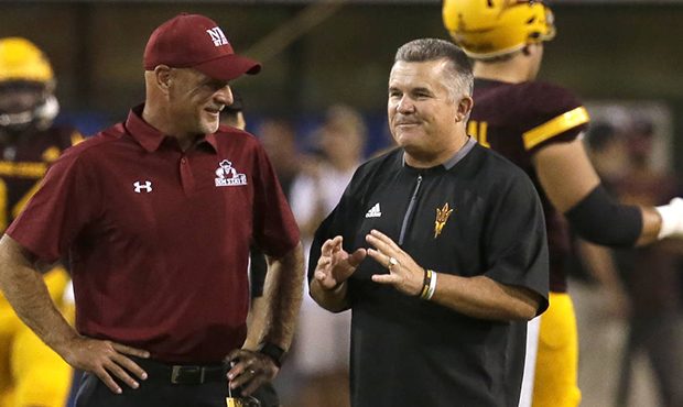 New Mexico State coach Doug Martin, left, and Arizona State coach Todd Graham talk before an NCAA c...