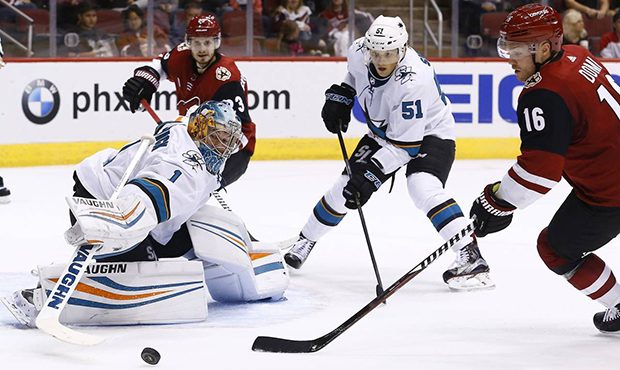 San Jose Sharks' Troy Grosenick (1) makes a save on a shot as Arizona Coyotes' Max Domi (16) and Sh...