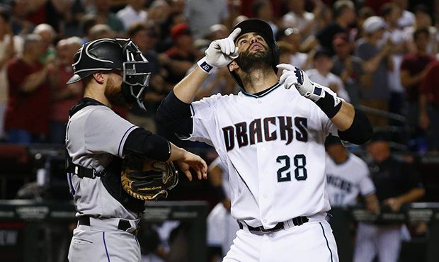 Arizona Diamondbacks' J.D. Martinez (28) points to the sky as he arrives at home plate in front of ...