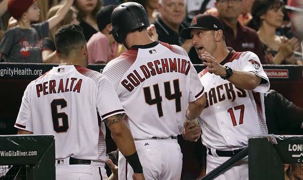 Arizona Diamondbacks' Paul Goldschmidt (44) is greeted in the dugout by manager Torey Lovullo (17) ...