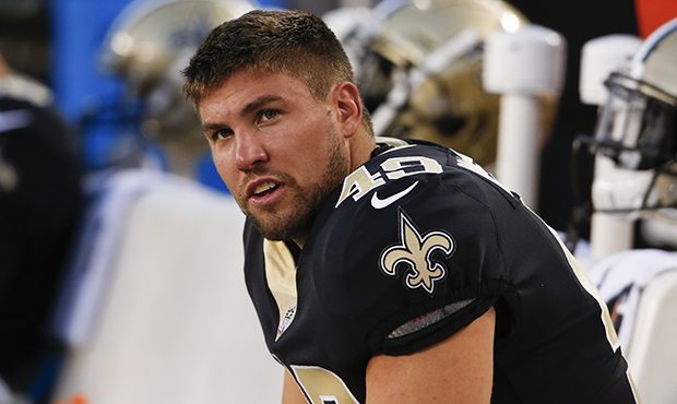 New Orleans Saints long snapper Justin Drescher sits on the bench during the first half of an NFL p...
