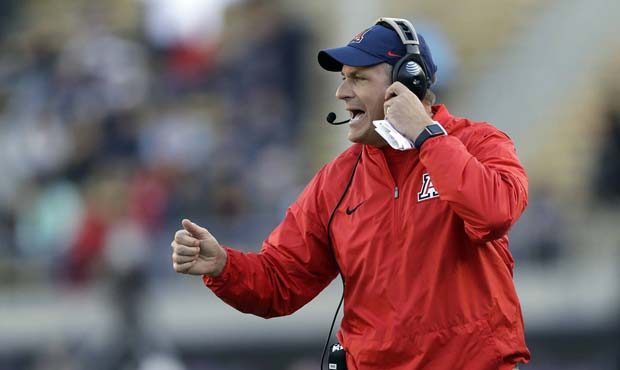 Arizona head coach Rich Rodriguez yells from the sideline during the first half of an NCAA college ...