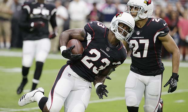 Arizona Cardinals running back Adrian Peterson (23) runs the with ball as he moves past Arizona Car...