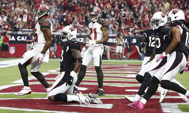 Arizona Cardinals running back Adrian Peterson, second from left, kneels after scoring a touchdown ...