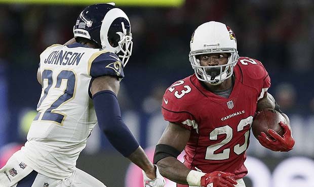Arizona Cardinals running back Adrian Peterson (23) runs with the ball chased by Los Angeles Rams c...