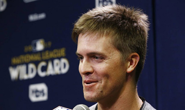 Arizona Diamondbacks pitcher Zack Greinke chuckles as he answers a question during a news conferenc...