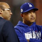 Los Angeles Dodgers manager Dave Roberts talks with general manager Farhan Zaidi prior to game 3 of baseball's National League Division Series against the Arizona Diamondbacks, Monday, Oct. 9, 2017, in Phoenix. (AP Photo/Ross D. Franklin)