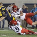 California running back Patrick Laird (28) scores on a rushing touchdown past Arizona linebacker Colin Schooler, right, and safety Jarrius Wallace (3) during the second half of an NCAA college football game Saturday, Oct. 21, 2017, in Berkeley, Calif. Arizona won 45-44 in two overtimes. (AP Photo/Marcio Jose Sanchez)