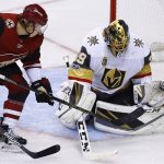 Vegas Golden Knights goalie Marc-Andre Fleury, right, makes a save on a shot by Arizona Coyotes center Christian Dvorak (18) during the third period of an NHL hockey game Saturday, Oct. 7, 2017, in Glendale, Ariz. The Golden Knights defeated the Coyotes 2-1 in overtime. (AP Photo/Ross D. Franklin)