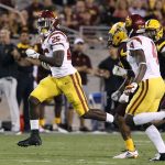 Southern California running back Ronald Jones II (25) runs past Arizona State defensive back Chad Adams, center, and teammate Steven Mitchell Jr. (4) as he breaks into the secondary on a touchdown run during the second half of an NCAA college football game, Saturday, Oct. 28, 2017, in Tempe, Ariz. (AP Photo/Ralph Freso)