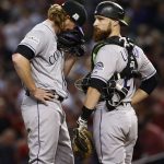 Colorado Rockies catcher Jonathan Lucroy talks with starting pitcher Jon Gray during the second inning before Gray was removed from the National League wild-card playoff baseball game against the Arizona Diamondbacks, Wednesday, Oct. 4, 2017, in Phoenix. (AP Photo/Ross D. Franklin)